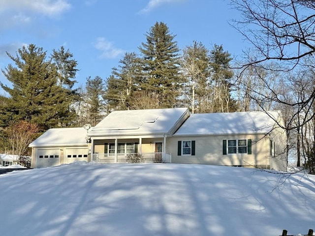 view of front of home featuring a porch and a garage