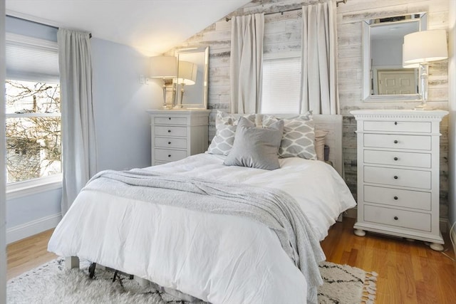 bedroom with light hardwood / wood-style flooring and lofted ceiling