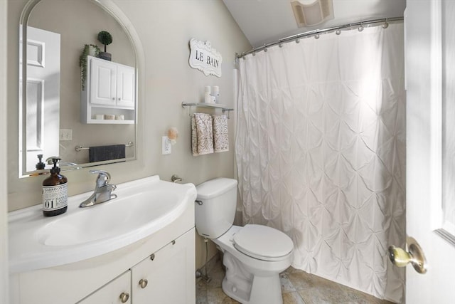 bathroom with vanity, toilet, walk in shower, and vaulted ceiling