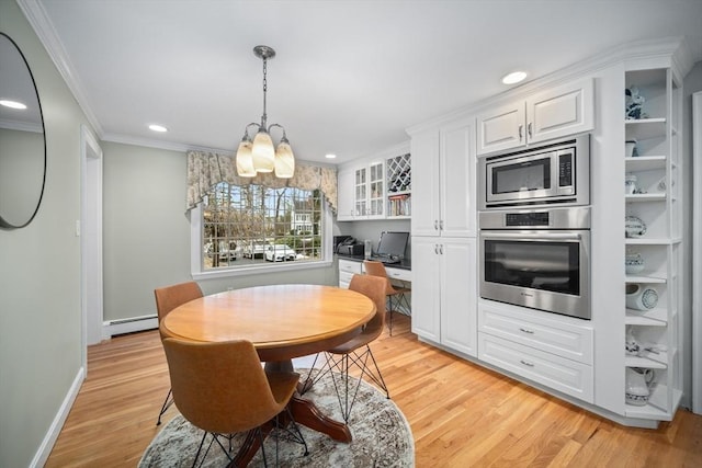 dining area with built in desk, a baseboard radiator, recessed lighting, light wood-style floors, and ornamental molding