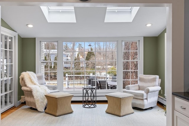 sitting room with a baseboard heating unit, a skylight, and recessed lighting