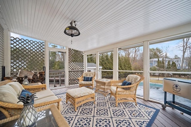 sunroom / solarium with a wealth of natural light and vaulted ceiling