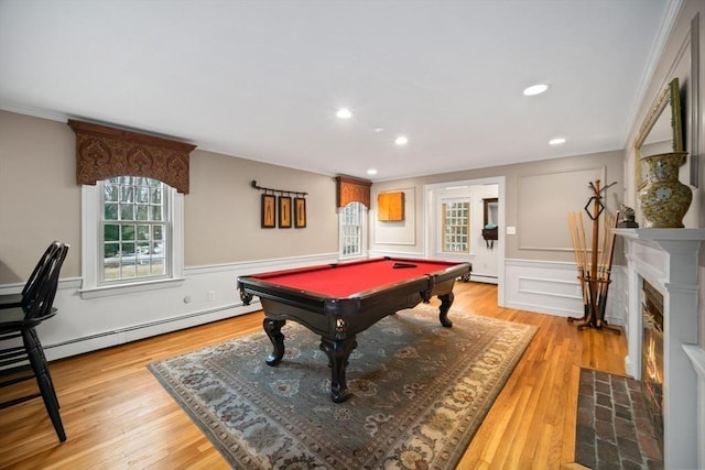 playroom with light wood finished floors, a fireplace with flush hearth, a baseboard heating unit, and pool table