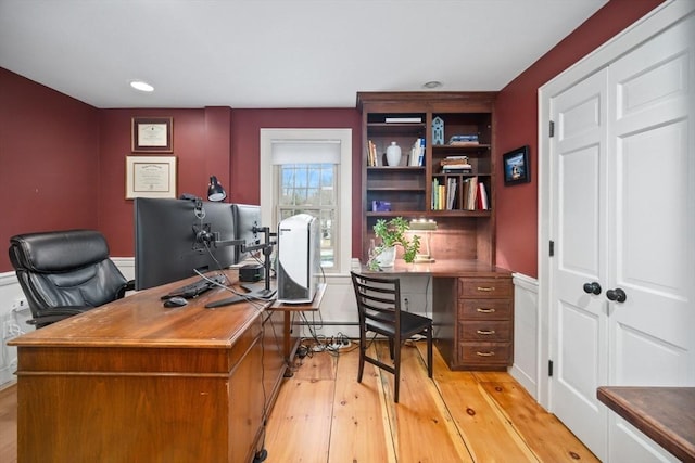 office with light wood-style floors and recessed lighting