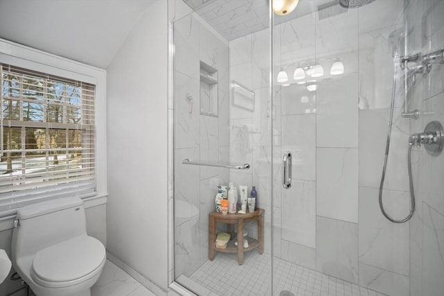 bathroom featuring a marble finish shower, marble finish floor, baseboards, and toilet