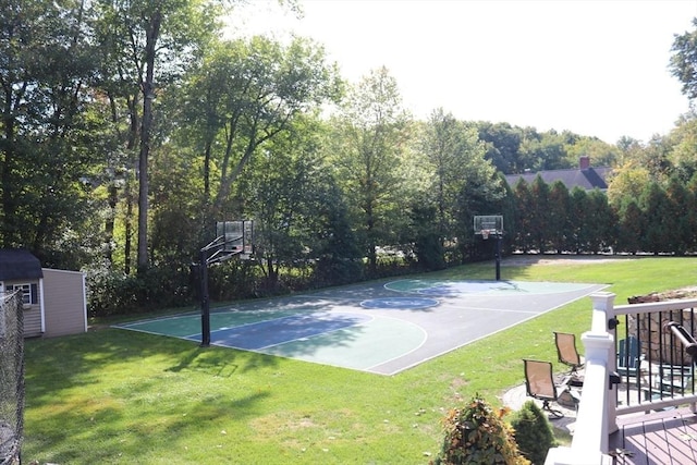 view of sport court featuring a storage shed, community basketball court, and a yard