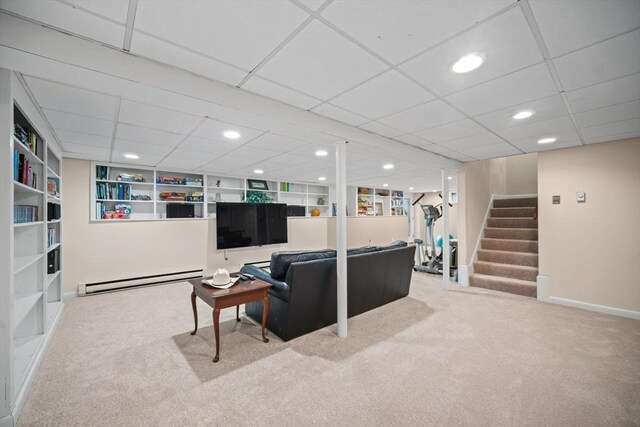 living area featuring stairs, a baseboard radiator, baseboards, and carpet