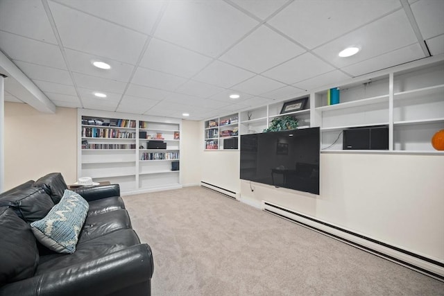 carpeted living area featuring a baseboard radiator, built in shelves, baseboard heating, and recessed lighting