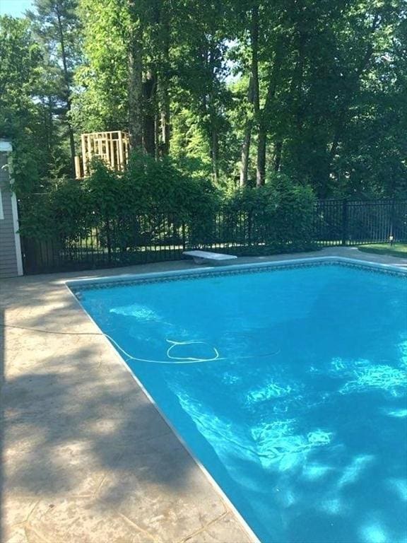 view of swimming pool featuring fence and a fenced in pool