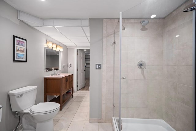 full bath featuring vanity, a stall shower, tile patterned flooring, and toilet