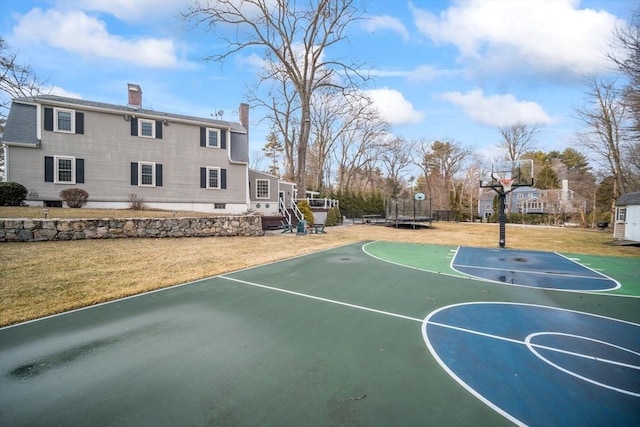 view of sport court with basketball court and a yard