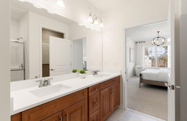 2 Codman Way Unit 311, Westborough, MA 01581 - full bathroom with double vanity, marble look tiles, ensuite bathroom, an enclosed shower, and a chandelier