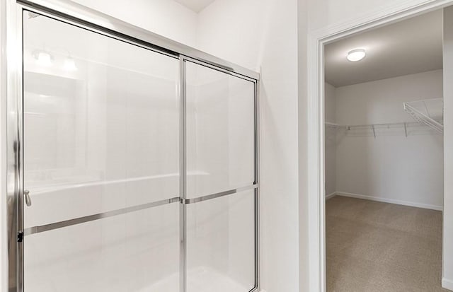 2 Codman Way Unit 311, Westborough, MA 01581 - bathroom featuring a shower stall, a walk in closet, and baseboards
