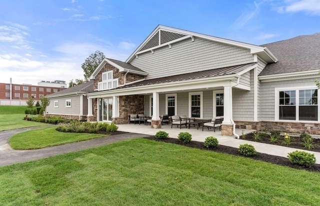 2 Codman Way Unit 311, Westborough, MA 01581 - rear view of house featuring stone siding, a lawn, a standing seam roof, and metal roof