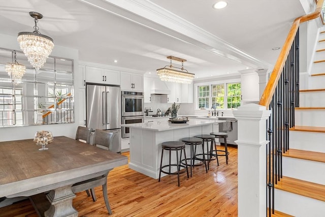 37-1/2 Federal St, Newburyport, MA 01950 - kitchen with appliances with stainless steel finishes, a center island, crown molding, a sink, and light countertops