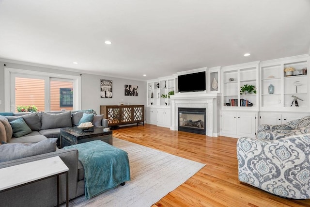 37-1/2 Federal St, Newburyport, MA 01950 - living area featuring light wood-type flooring, recessed lighting, a glass covered fireplace, and ornamental molding