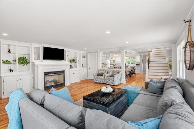 37-1/2 Federal St, Newburyport, MA 01950 - living room with light wood-type flooring, a glass covered fireplace, recessed lighting, stairway, and crown molding