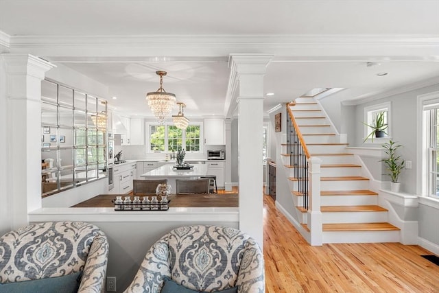 37-1/2 Federal St, Newburyport, MA 01950 - living area with light wood-style floors, ornate columns, ornamental molding, stairs, and recessed lighting