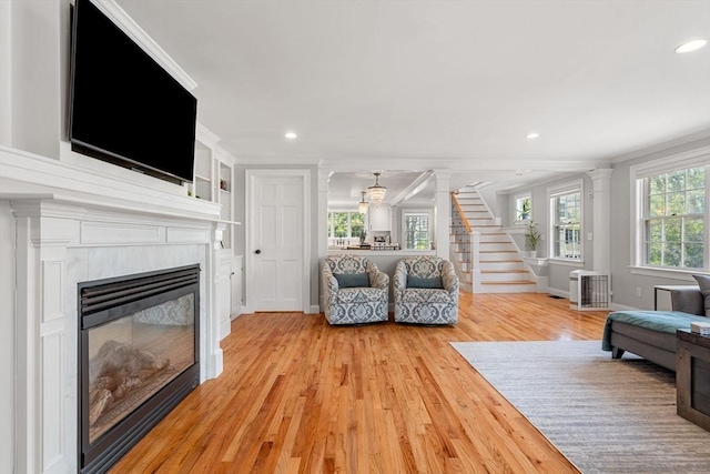37-1/2 Federal St, Newburyport, MA 01950 - living area featuring crown molding, light wood finished floors, recessed lighting, a glass covered fireplace, and stairway