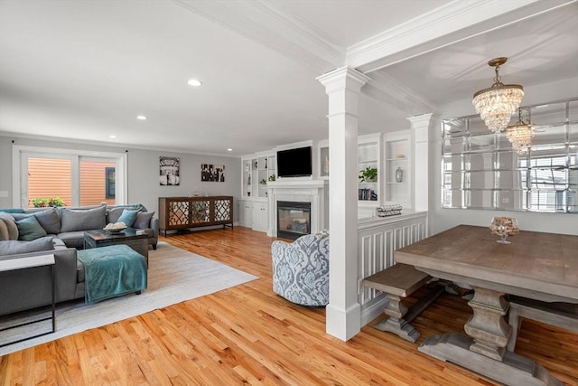 37-1/2 Federal St, Newburyport, MA 01950 - living room with crown molding, a glass covered fireplace, recessed lighting, wood finished floors, and decorative columns