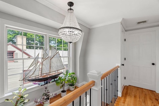 37-1/2 Federal St, Newburyport, MA 01950 - hallway featuring a chandelier, an upstairs landing, light wood-type flooring, ornamental molding, and baseboards