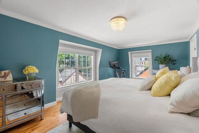 37-1/2 Federal St, Newburyport, MA 01950 - bedroom featuring multiple windows, ornamental molding, a chandelier, wood finished floors, and baseboards