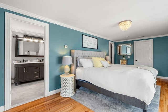 37-1/2 Federal St, Newburyport, MA 01950 - bedroom featuring wood finished floors, baseboards, crown molding, and connected bathroom