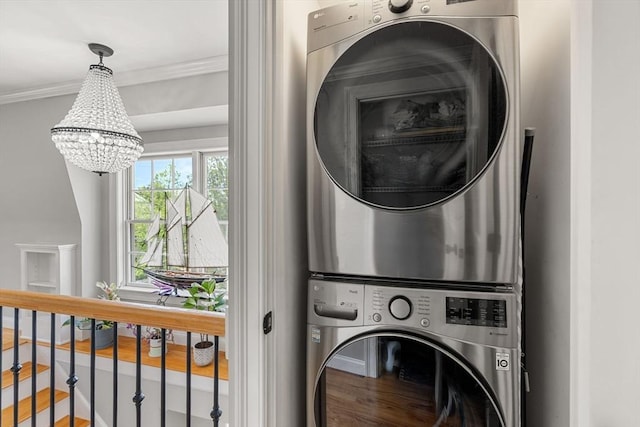 37-1/2 Federal St, Newburyport, MA 01950 - laundry room with stacked washing machine and dryer, a chandelier, wood finished floors, and ornamental molding