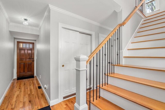 37-1/2 Federal St, Newburyport, MA 01950 - foyer with wood finished floors, crown molding, stairs, and baseboards