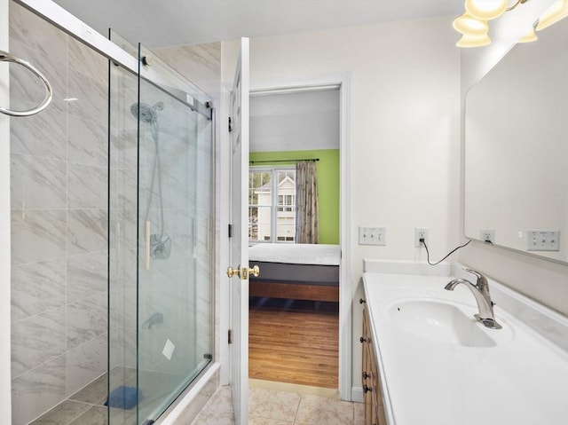 full bath with a stall shower, tile patterned flooring, vanity, and ensuite bathroom