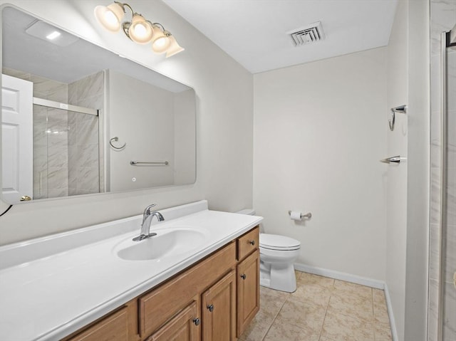 bathroom with toilet, vanity, visible vents, baseboards, and a shower stall