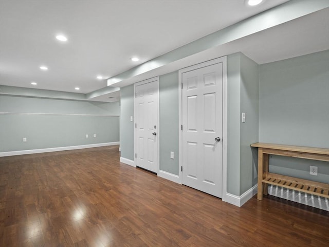 finished basement featuring recessed lighting, baseboards, and wood finished floors