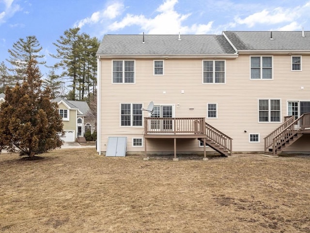 rear view of house featuring a wooden deck and stairs