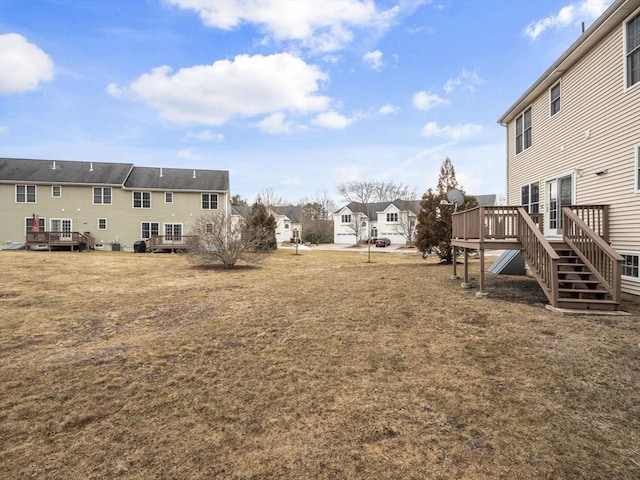 view of yard featuring a residential view and a wooden deck