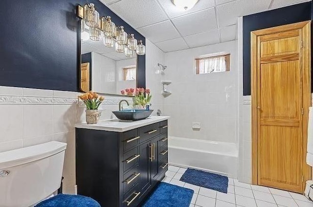 21 Parker St, Boston, MA 02129 - bathroom with tile patterned floors, toilet, bathtub / shower combination, vanity, and tile walls