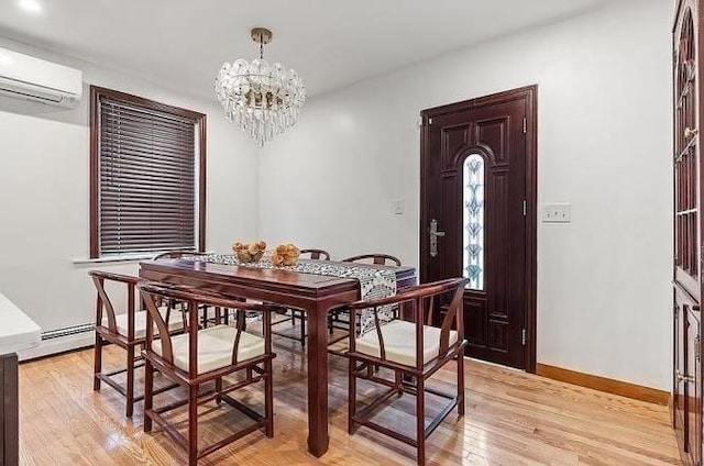 21 Parker St, Boston, MA 02129 - dining room with a wall mounted AC, a chandelier, light wood-style floors, and baseboards