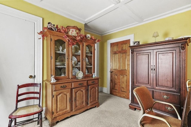 living area with crown molding and light colored carpet