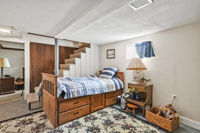 bedroom with a textured ceiling and carpet flooring