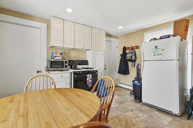 kitchen with stainless steel microwave, a baseboard heating unit, recessed lighting, gas range oven, and freestanding refrigerator