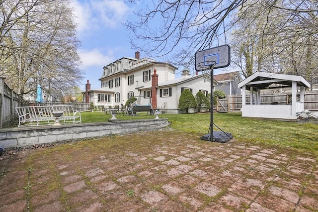 exterior space with a lawn, a gazebo, and a fenced backyard