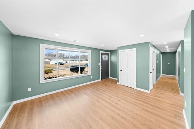 unfurnished room with recessed lighting, light wood-type flooring, and baseboards