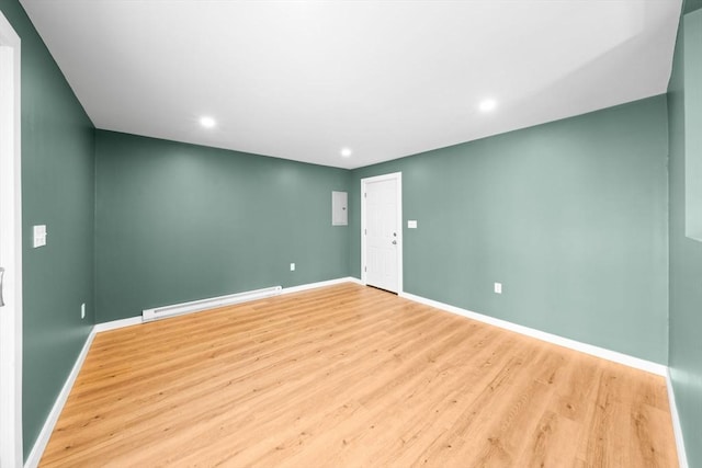 unfurnished room featuring recessed lighting, baseboards, baseboard heating, and light wood-style flooring