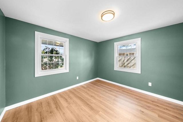 empty room with wood finished floors and baseboards