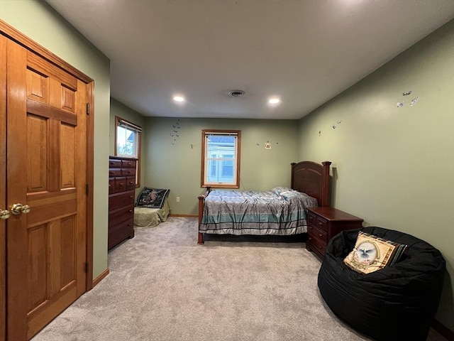 bedroom with light colored carpet