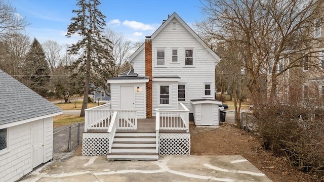 back of property featuring a wooden deck