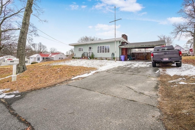 view of front of property featuring a carport