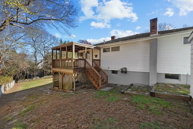 rear view of property featuring a wooden deck