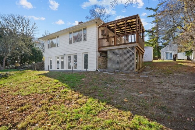 back of house with a deck, a yard, and french doors