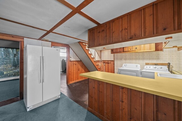 kitchen featuring independent washer and dryer and white refrigerator