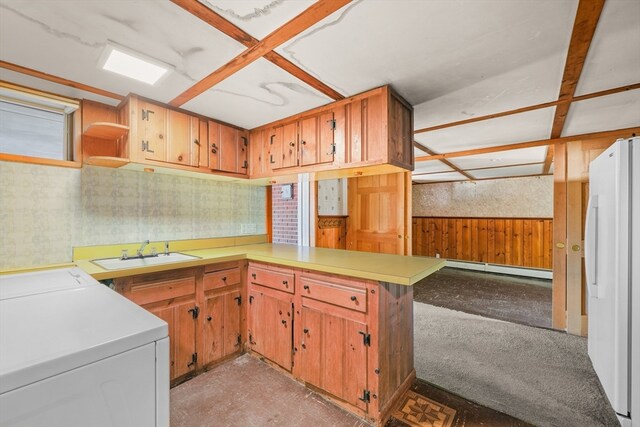 kitchen featuring kitchen peninsula, sink, white refrigerator, a baseboard radiator, and washer / dryer